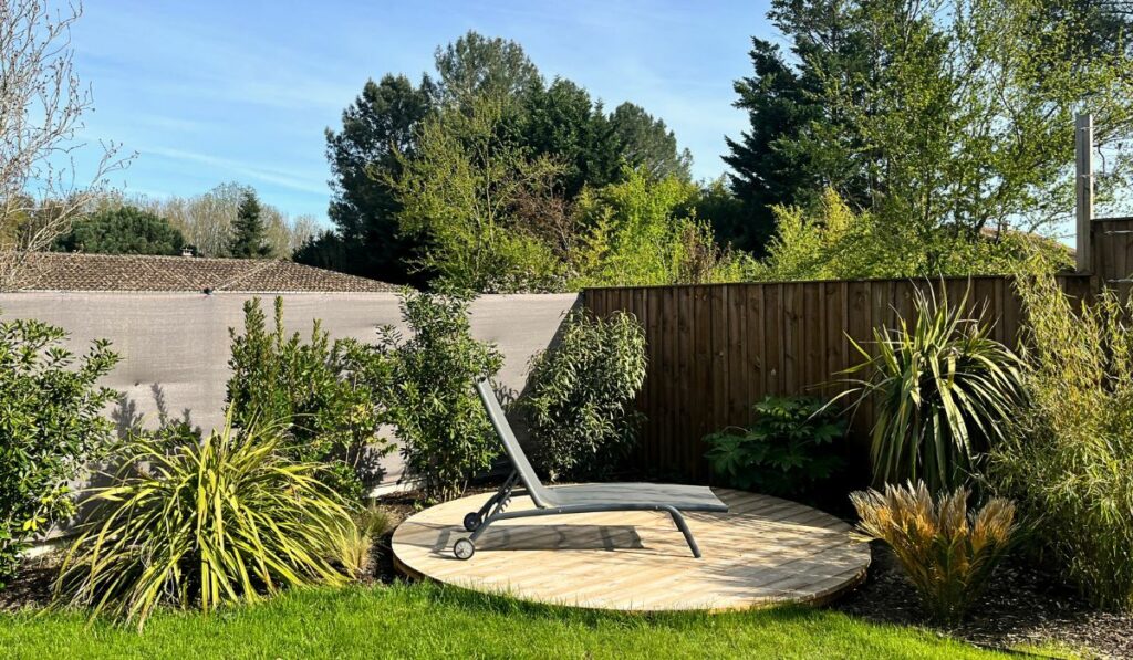 Terrasse ronde en pin sur pelouse pour espace détente à Bordeaux par TO L’Atelier des Jardins